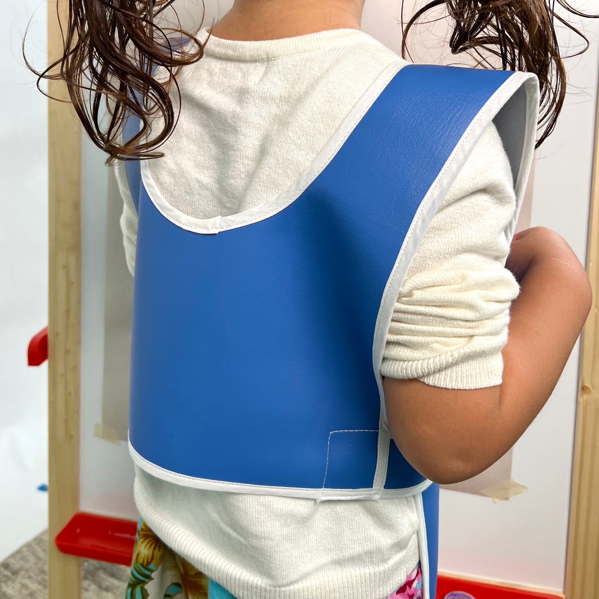 Child's blue durable washable waterproof vinyl rolled Primary Montessori apron