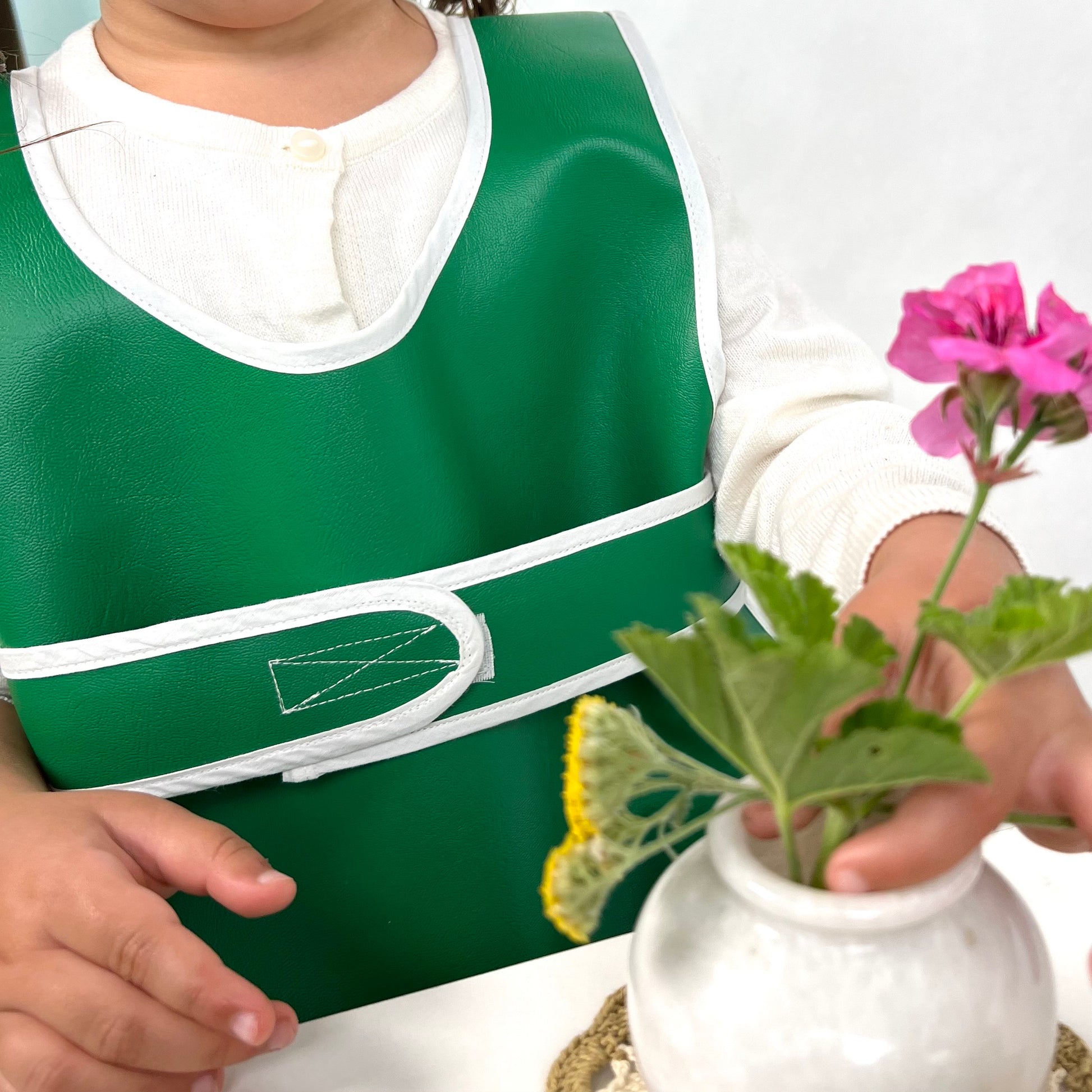 Child's green durable washable waterproof vinyl rolled Primary Montessori apron